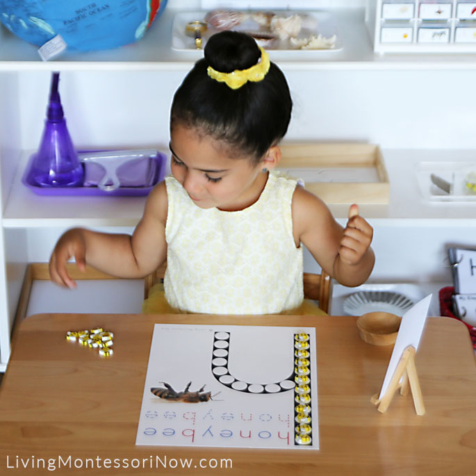 Carefully Lining up Bee Erasers on Honeybee Do-a-Dot Printable