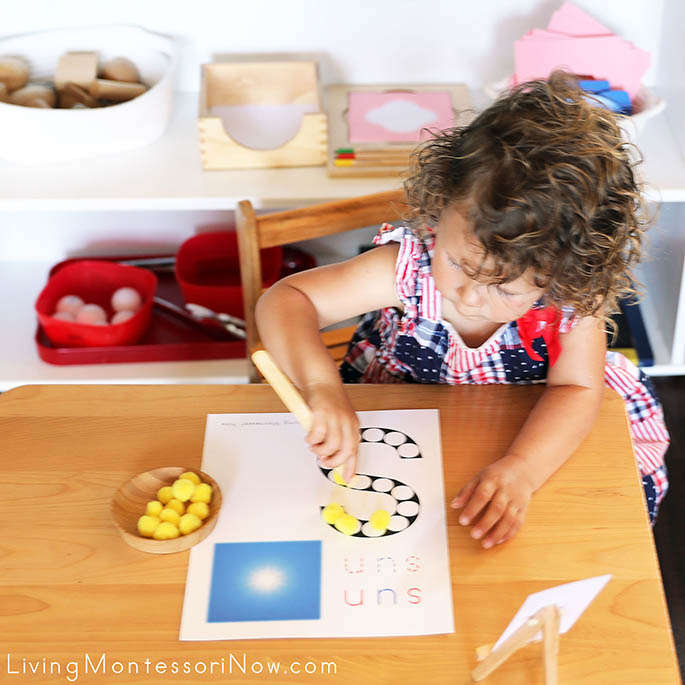 Concentrating on Using Toast Tongs to Transfer Pom Poms to the Sun Do-a-Dot Printable