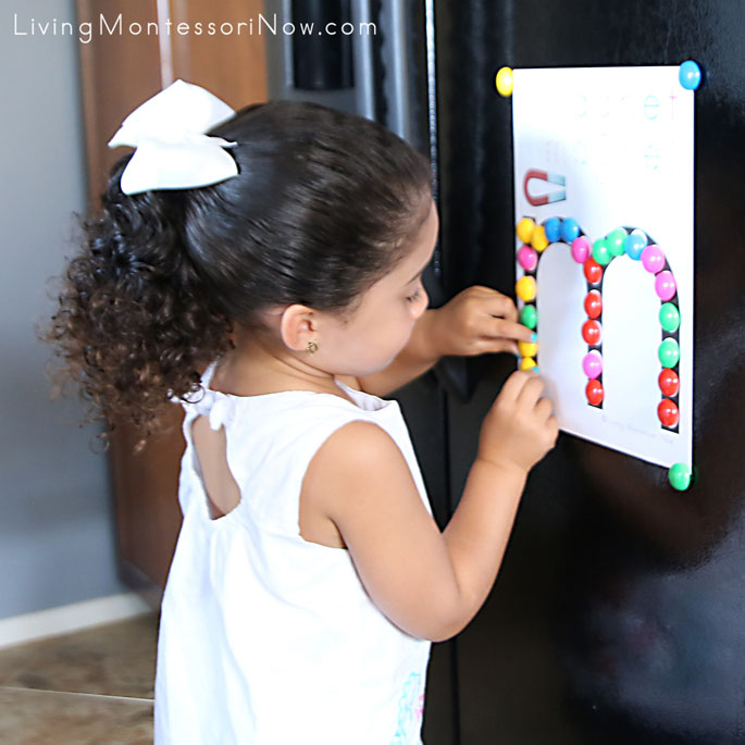 Placing Power Magnets on Do-a-Dot Letter M on Refrigerator